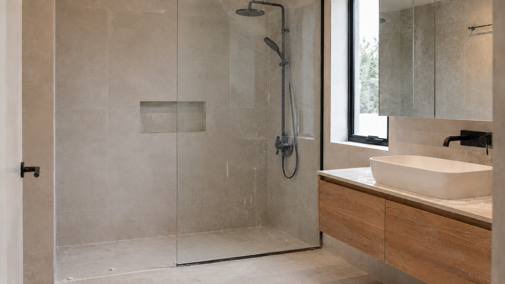 Bathroom before builders clean — construction dust and residue on tiles and glass